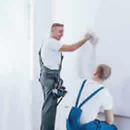 Decorators Finishing a Wall